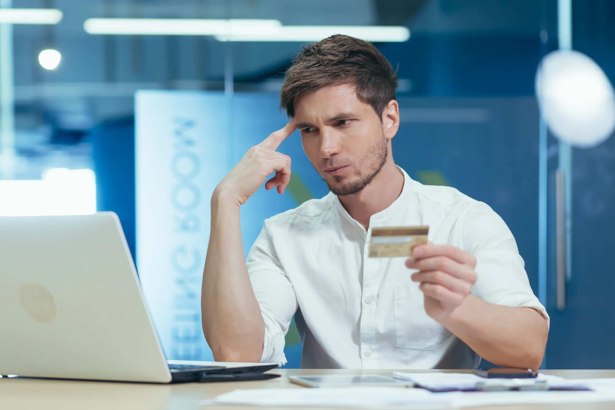 holiday man checking expiry date on his stolen card to look for suspicious payments and unauthorised credit card purchases